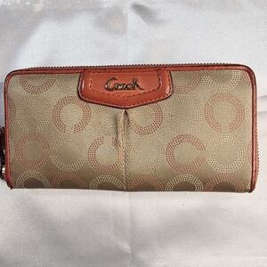 Coach Ashley Dotted Op Art zip-around wallet in a khaki and pink/peach color